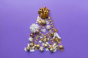 Christmas tree made from colored ball decoration on colored background, view from above. New Year minimal concept with copy space photo