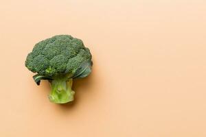 Top view fresh green broccoli vegetable on Colored background. Broccoli cabbage head Healthy or vegetarian food concept. Flat lay. Copy space photo