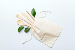 Eco friendly reusable recyclable white eco bag with kitchenware on Colored background. Concept zero waste photo