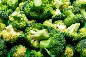 green fresh broccoli background close up on colored table. Vegetables for diet and healthy eating. Organic food photo