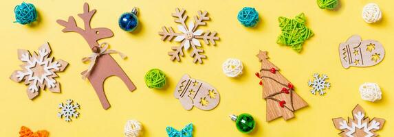 Top view Banner of yellow background with New Year toys and decorations. Christmas time concept photo