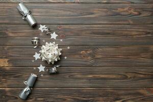 Christmas crackers with shiny confetti on color background, top view, copy space photo