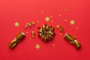 Christmas crackers with shiny confetti on color background, top view, copy space photo