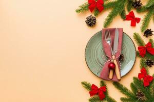 Christmas table place setting with christmas decor and plates, kine, fork and spoon. Christmas holiday background. Top view with copy space photo