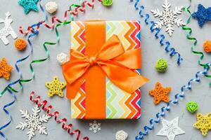 Christmas composition. Gifts box with new year decorations on colored background. Christmas, winter, new year concept. Flat lay, top view, copy space photo
