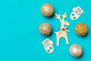 New Year composition made of baubles, reindeer and other decorations on colorful background. Christmas time concept with empty space for your design photo