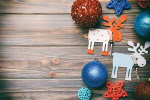 Winter set made of Christmas balls and various decorations on holiday wooden background. Top view of New Year concept with copy space photo