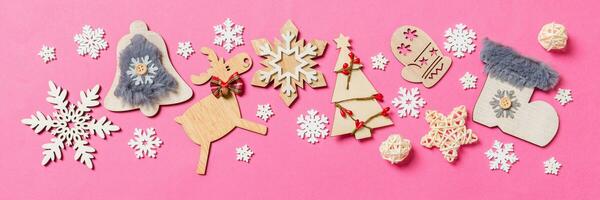 Top view Banner of holiday decorations and toys on pink background. Christmas ornament concept with empty space for your design photo