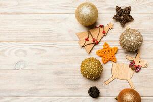 New Year composition made of baubles, reindeer and other decorations on wooden background. Christmas time concept with empty space for your design photo