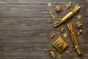 Christmas crackers with shiny confetti on color background, top view, copy space photo