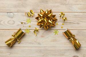 Christmas crackers with shiny confetti on color background, top view, copy space photo