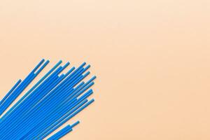 Heap of colorful plastic drinking straws on Colored background, flat lay. Copy Space for text photo