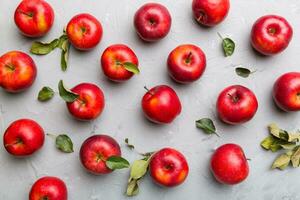Many red apples on colored background, top view. Autumn pattern with fresh apple above view photo