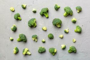 green fresh broccoli background close up on colored table. Vegetables for diet and healthy eating. Organic food photo