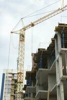 Industrial background made of crane construction at the buildings background at the building area photo