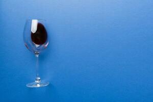 One glasses of red wine at wine tasting. Concept of red wine on colored background. Top view, flat lay design photo