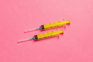 Top view of medical syringes on colorful background. Health care concept with copy space photo