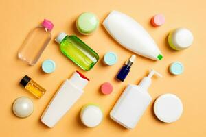 Group of plastic bodycare bottle Flat lay composition with cosmetic products on colored background empty space for you design. Set of White Cosmetic containers, top view with copy space photo