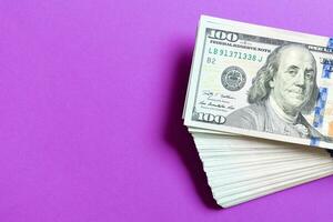 Top view of bundle of 100 dollar bill on colorful backgound. Business concept with copy space photo