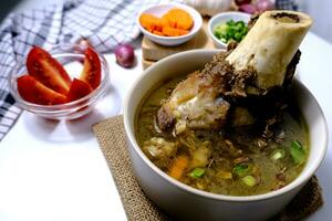 Bone soup or rib soup is a menu served in a bowl photo