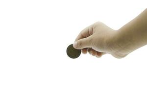 child hand holding a coin from the top isolated on white background, clipping path included. Copy space for your text photo