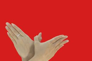 Hands of a woman on a red background with space for text photo