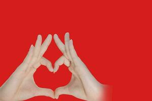 girl hand making shape heart and 3d red heart symbol for love on freen blur boke background photo