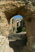 view through a stone arch of the bridge crossing at Ronda photo