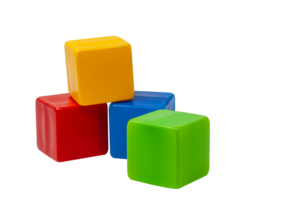 Multicolored plastic cubes for children's games. The yellow cube stands on top of the red and blue, the green one next to it. No background. One on one. High quality photo. png