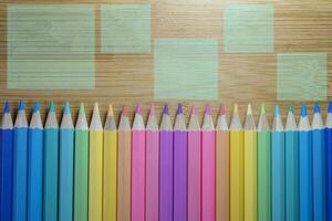 Pattern of colored pencils placed in a straight row with pencil tips on a close-up wooden table background, Colored pencils, Copy space, pastel concept, background concept, educational concept photo