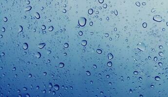 Beautiful raindrops on a window, Raindrops Or Vapor Trough on the glass, Abstract of raindrops on the mirror with a colored background. Drops of water - Image photo