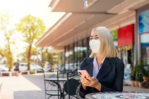 Attractive young businesswoman thinking about how to lead a successful business while holding a phone. photo