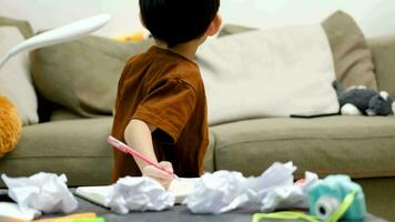 Asian boy drawing on table And there was a piece of paper left on the table. video