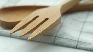 wooden cutlery fork and spoon on a chopping board on table video