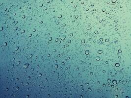 Beautiful raindrops on a window, Raindrops Or Vapor Trough on the glass, Abstract of raindrops on the mirror with a colored background. Drops of water - Image photo