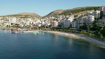 Sarande Albania August 2023 Exploring of the albanian public swimming beach riviera bay morning time summer feelings albanians aerial drone footage high quality cinematography clips video