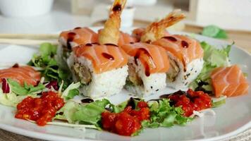 Overhead japanese sushi food. Maki ands rolls with salmon, shrimp, crab and avocado. Top view of assorted sushi, all you can eat menu. Rainbow sushi roll, uramaki, hosomaki and nigiri. video