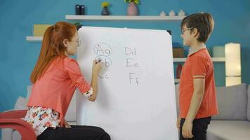 professor ensino dela Garoto aluna a alfabeto. video