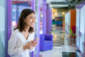 Mobile phone in her hand represents the importance of technology in today's business world, Digital marketing. photo