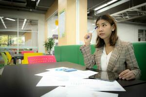 Beautiful asian businesswoman thinking about problems in the company, Copy space. photo