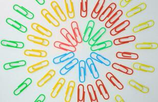 Paper clip, Paper clip multi colored lay in circle with white background, Office and school supplies concept. photo