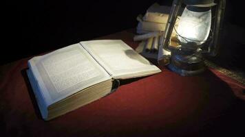 Historical book in the light of an old oil lamp. video