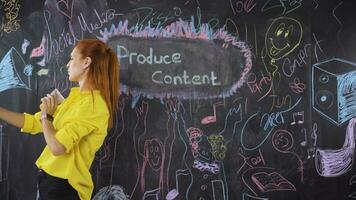 Young woman writing Creating Content on the chalkboard. video