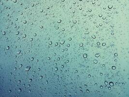 Beautiful raindrops on a window, Raindrops Or Vapor Trough on the glass, Abstract of raindrops on the mirror with a colored background. Drops of water - Image photo