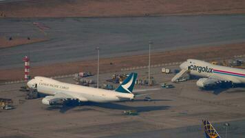 HONG KONG NOVEMBER 09, 2019 - Cathay Pacific Cargo and Cargolux on the airfield at Hong Kong airport, top view. Boeing 747 parked, unloading the cargo hold video