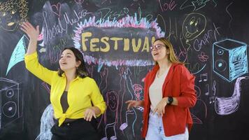 Young woman writing Festival on blackboard. video