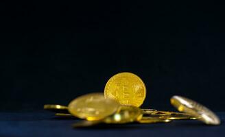 Golden Bitcoin, Bitcoin in the middle of circle of stack on dark blue background. Crypto currency concept. photo