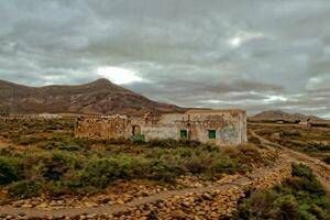 empty mysterious mountainous landscape from the center of the Canary Island Spanish Fuerteventura with a cloudy sky photo