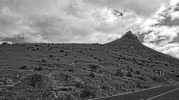empty mysterious mountainous landscape from the center of the Canary Island Spanish Fuerteventura with a cloudy sky photo