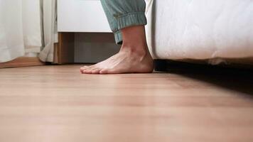 getting up in the morning. low section view of female feet standing on floor after waking up video